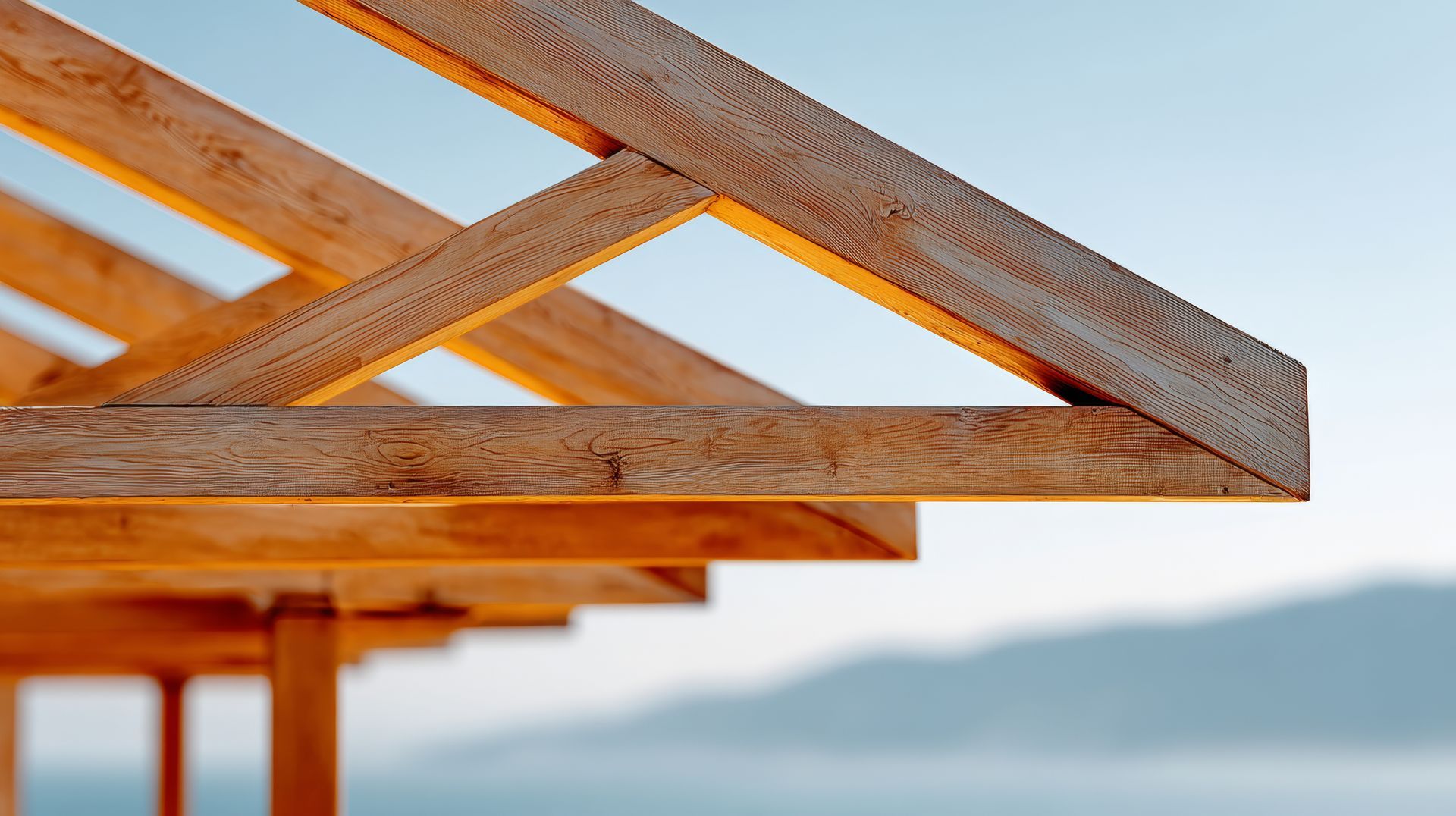 Closeup to the corner of timber roof trusses with blurred background.