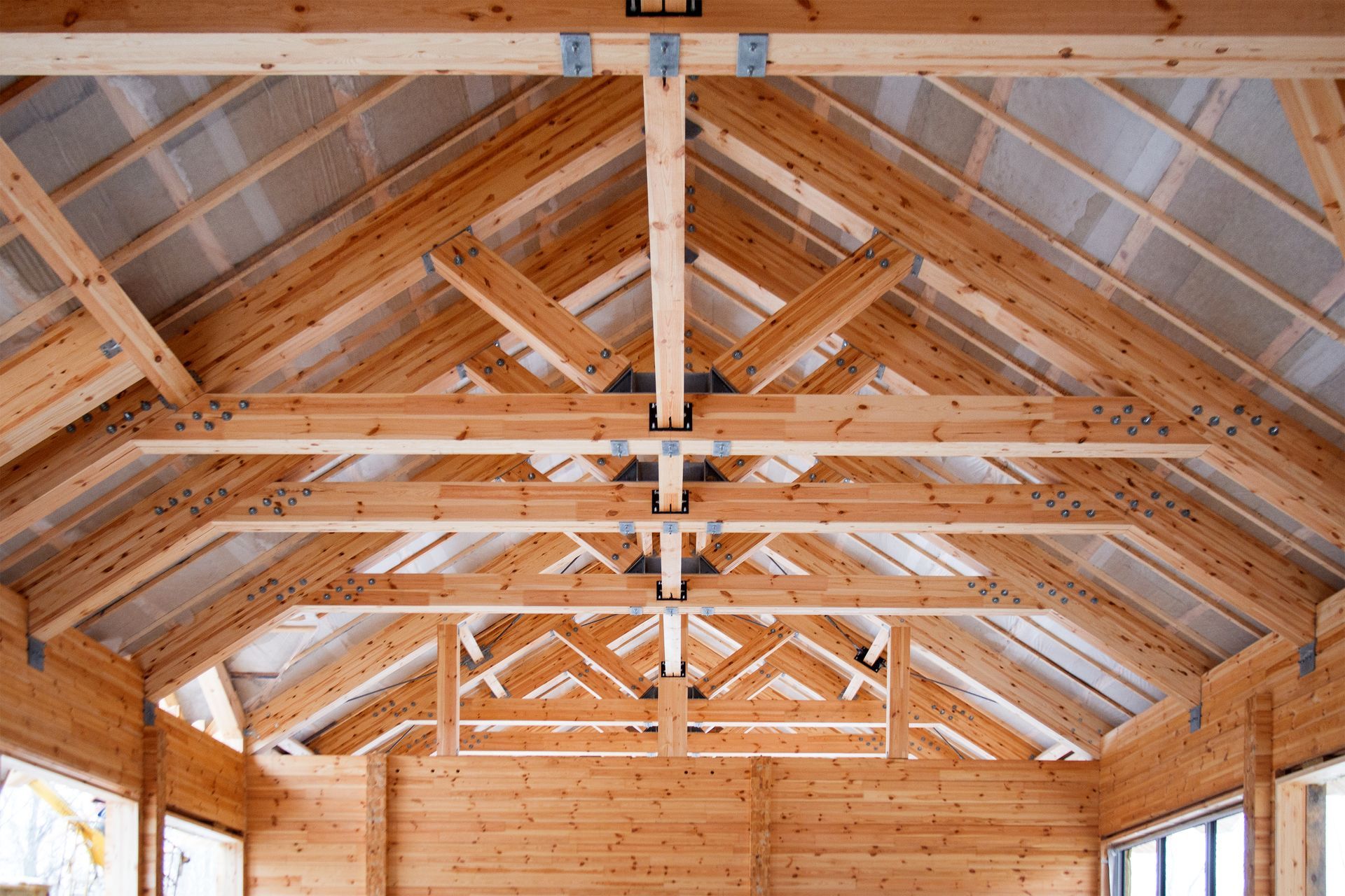 Interior view of a wooden truss structure.