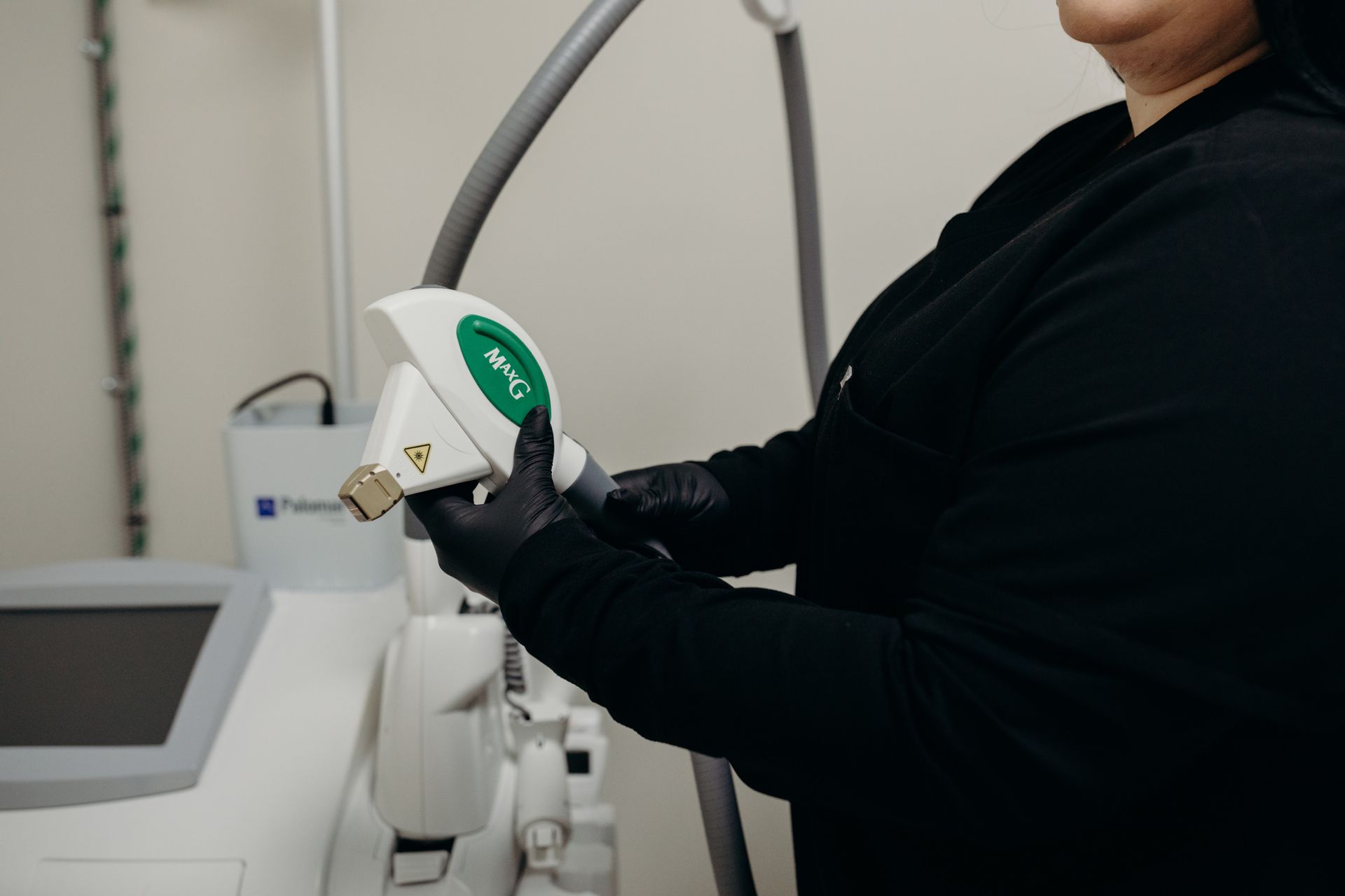 A woman is holding a machine in her hands in a room.