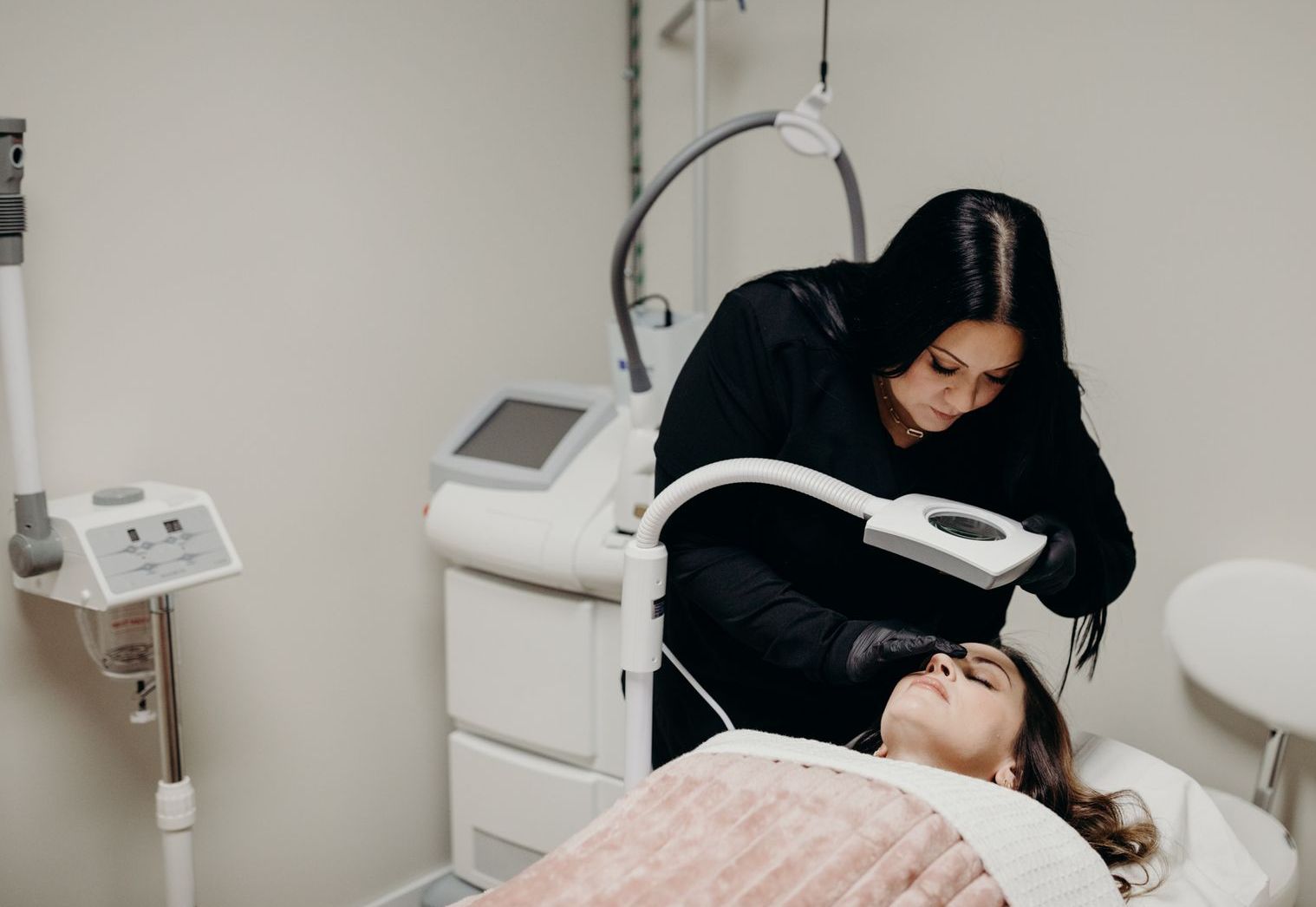 A woman is getting a facial treatment in a beauty salon.