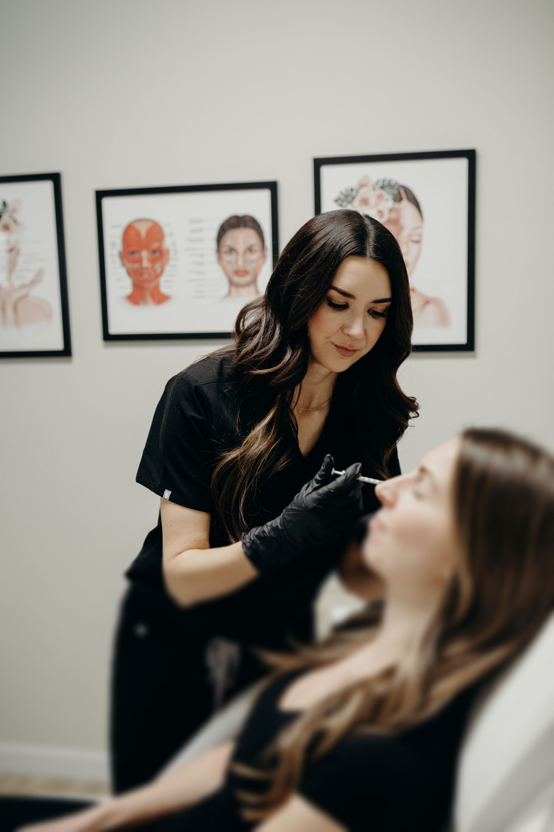 A woman is getting a botox injection in her nose.