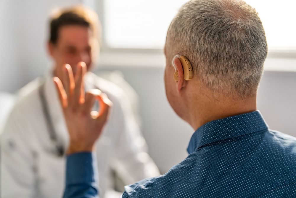 Doctor and Male Patient With Hearing Aid — Moama, NSW — Bathurst, NSW — Murray Hearing Services Doctor and Male Patient With Hearing Aid — Moama, NSW — Bathurst, NSW — Murray Hearing Services