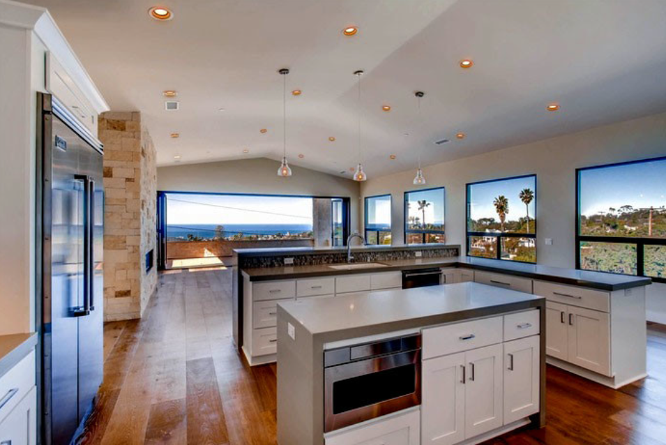 Spacious modern kitchen with island and recessed lighting.