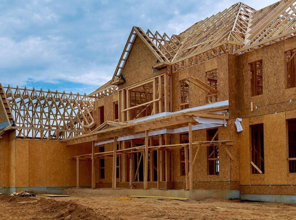 House under construction with exposed wooden frame and unfinished exterior.