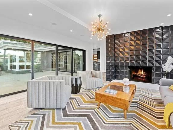 Contemporary dining room with glass walls and stylish chandelier.