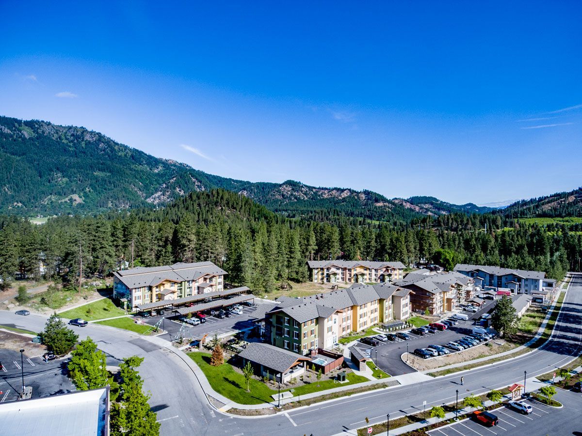 An aerial view of a residential area with mountains in the background.
