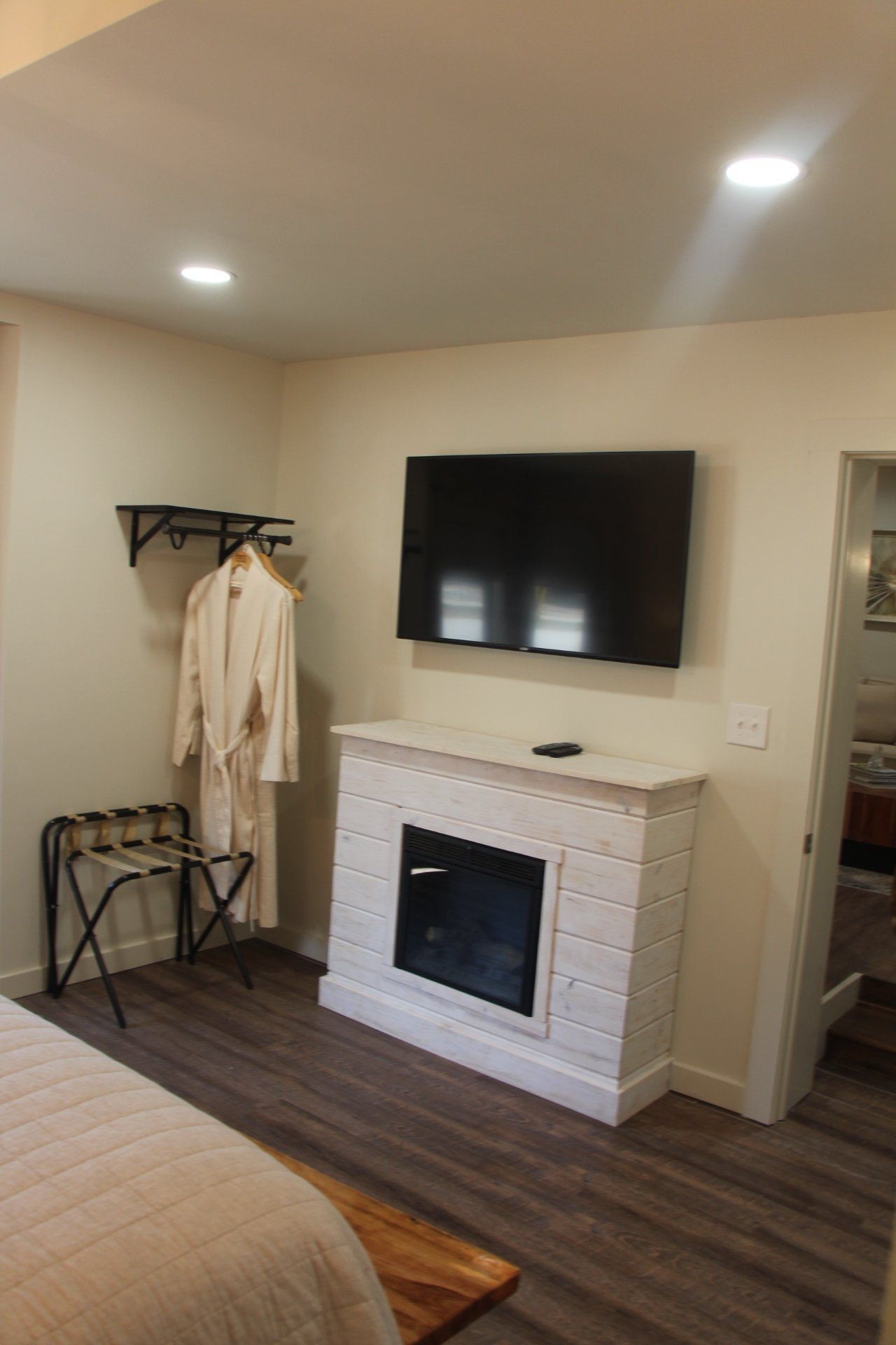 Fireplace and TV in bedroom of The Big Catch suite