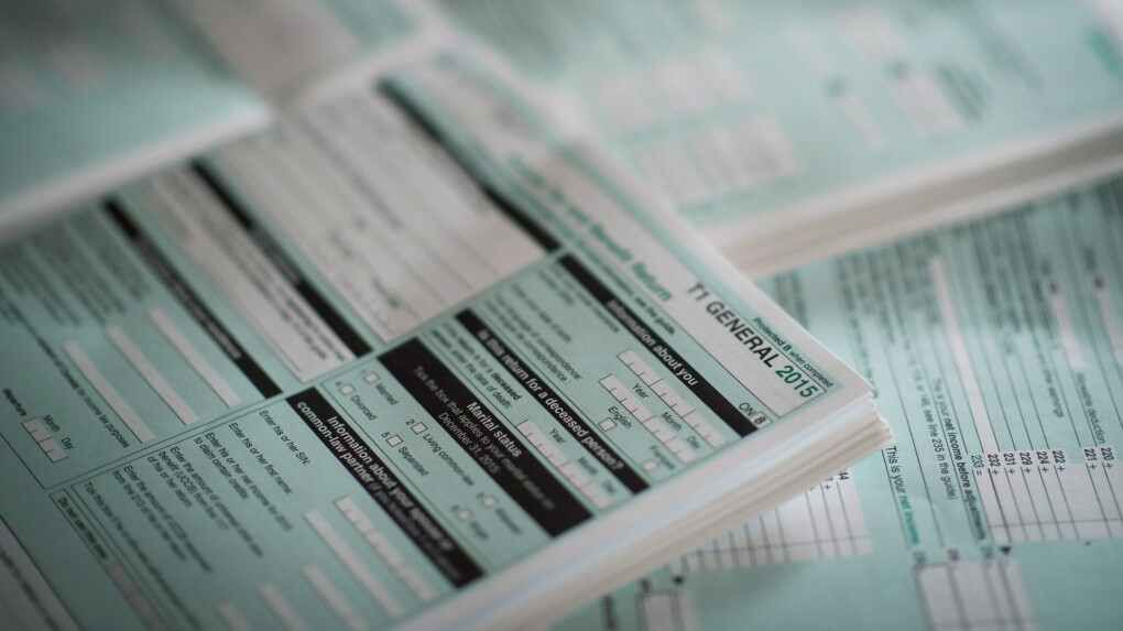 A stack of forms sitting on top of each other on a table.