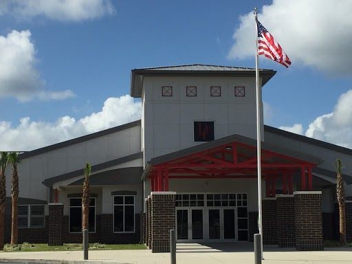 an american flag is flying in front of a building