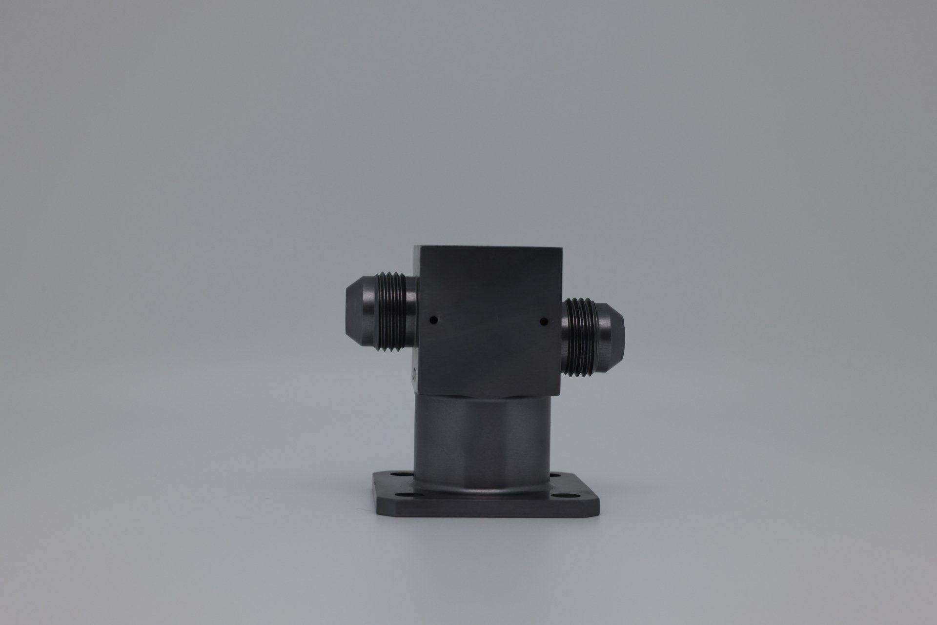 A black metal object is sitting on a white surface.