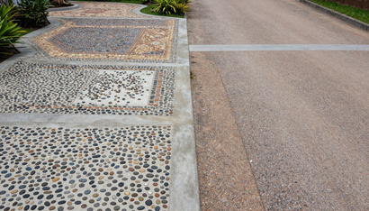 Decorative exposed aggregate walkway installed by Concrete Services in Renton WA for lasting beauty.