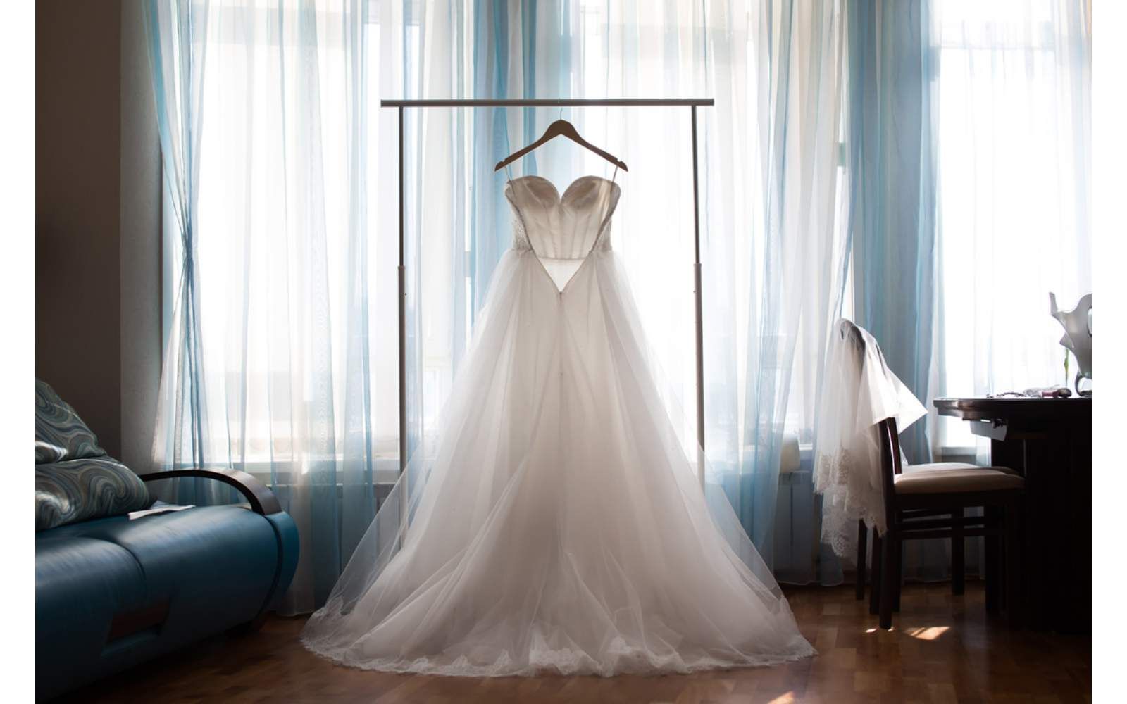 A Wedding Dress Is Hanging On A Rack In A Room — Macquarie Dry Cleaners In Dubbo, NSW