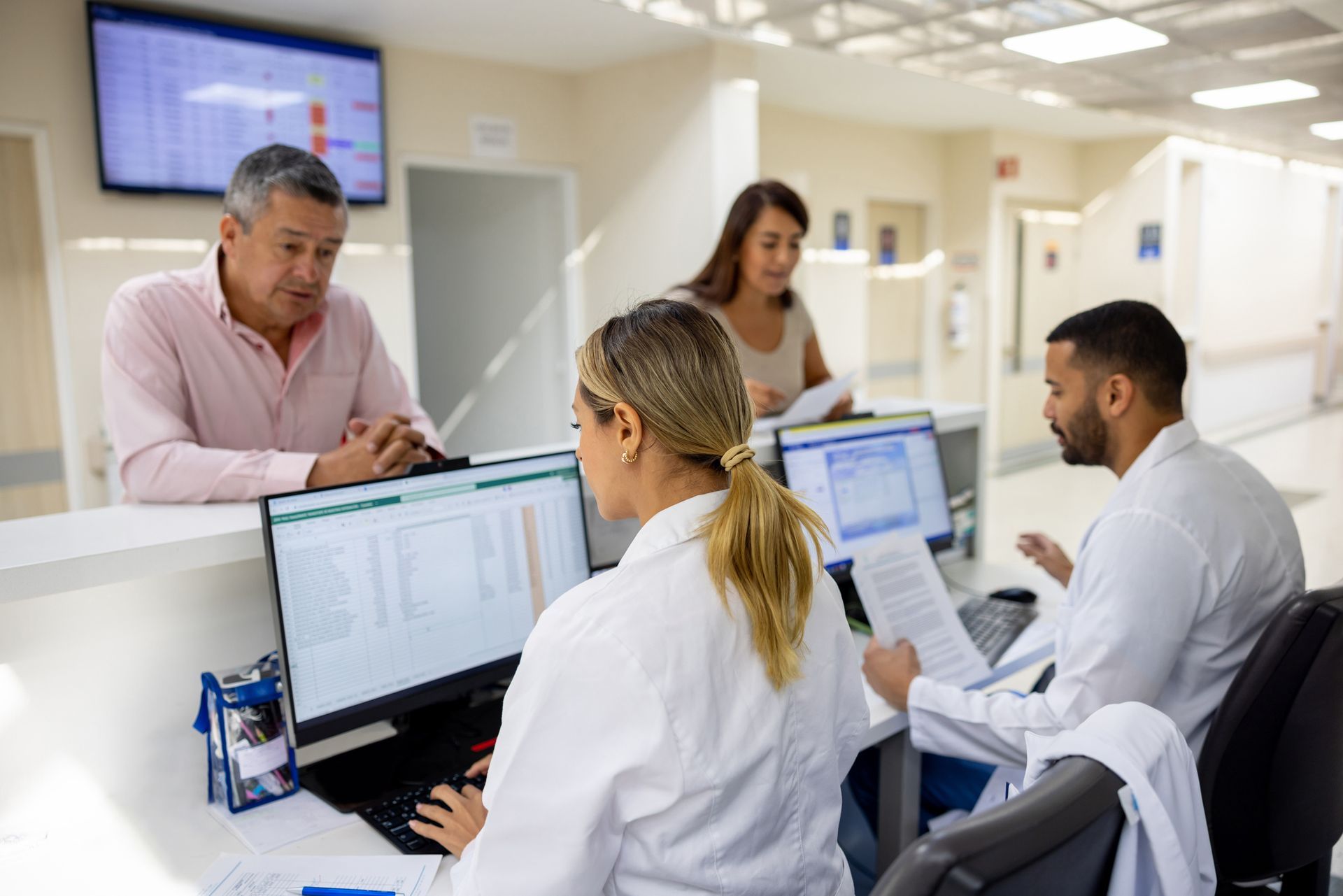 man and woman at a hospital check in desk