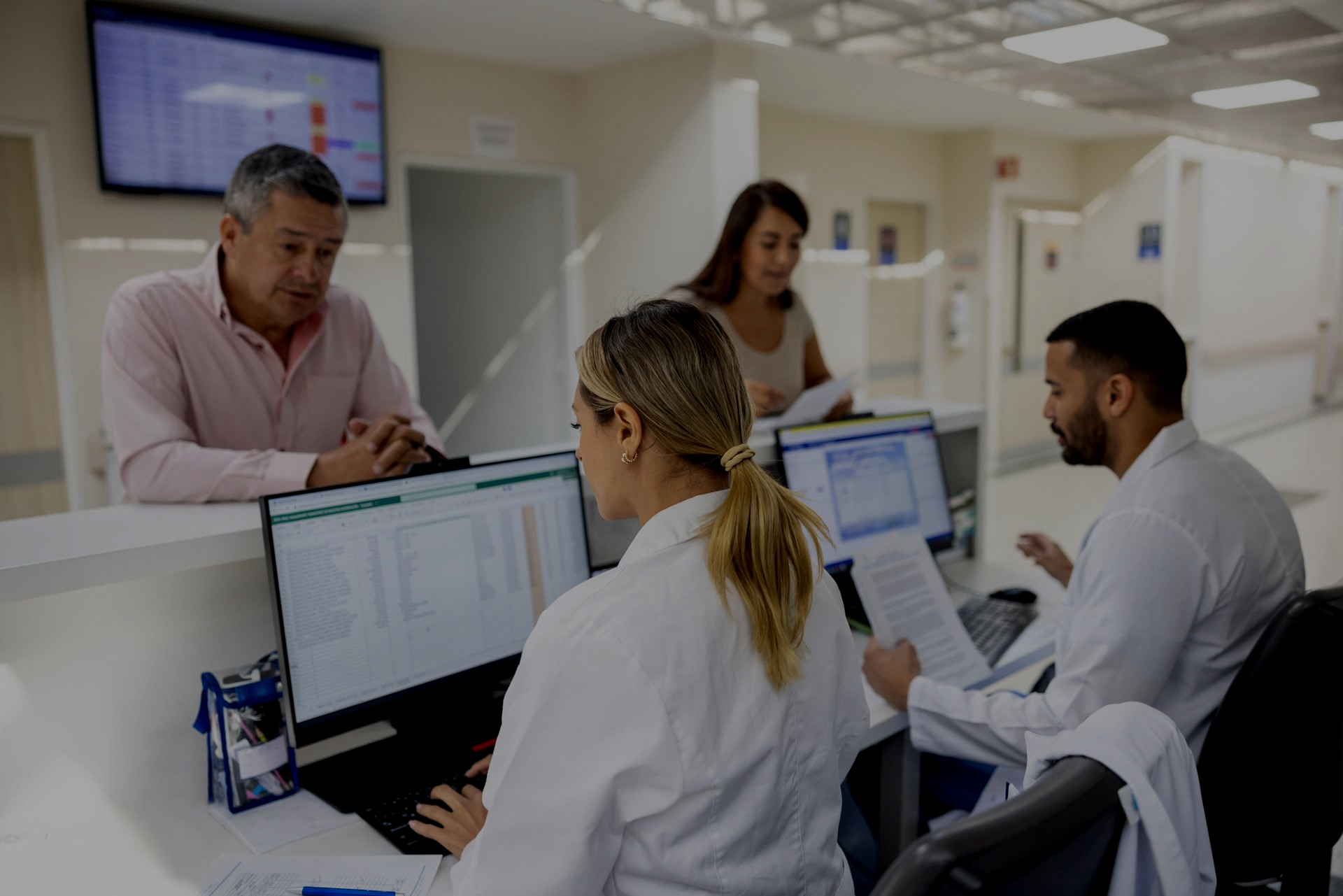 man and woman at a hospital check in desk