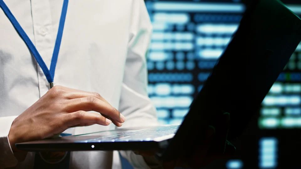 man standing at laptop giving a presentation