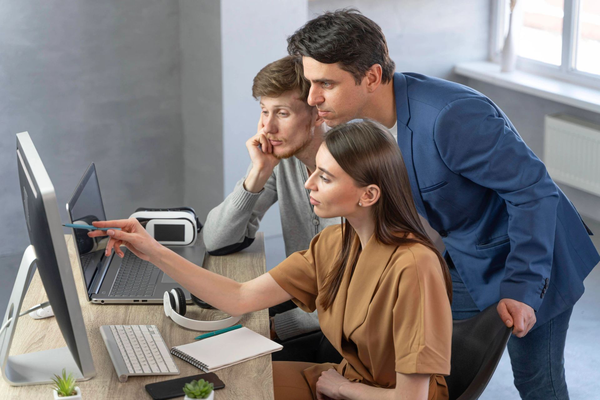 workers viewing a computer screen as they are trained on new technology