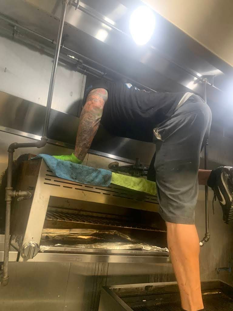 Worker Cleaning the Commercial Kitchen