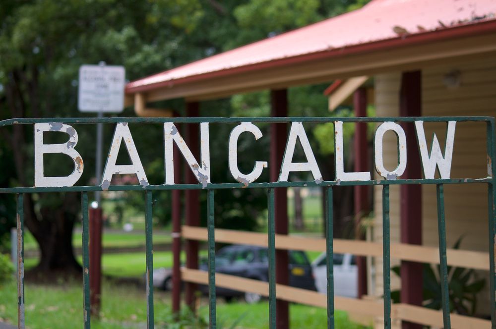 A Green Fence With the Word Bangalow Written on It — Goonellabah Denture Clinic In Bangalow, NSW