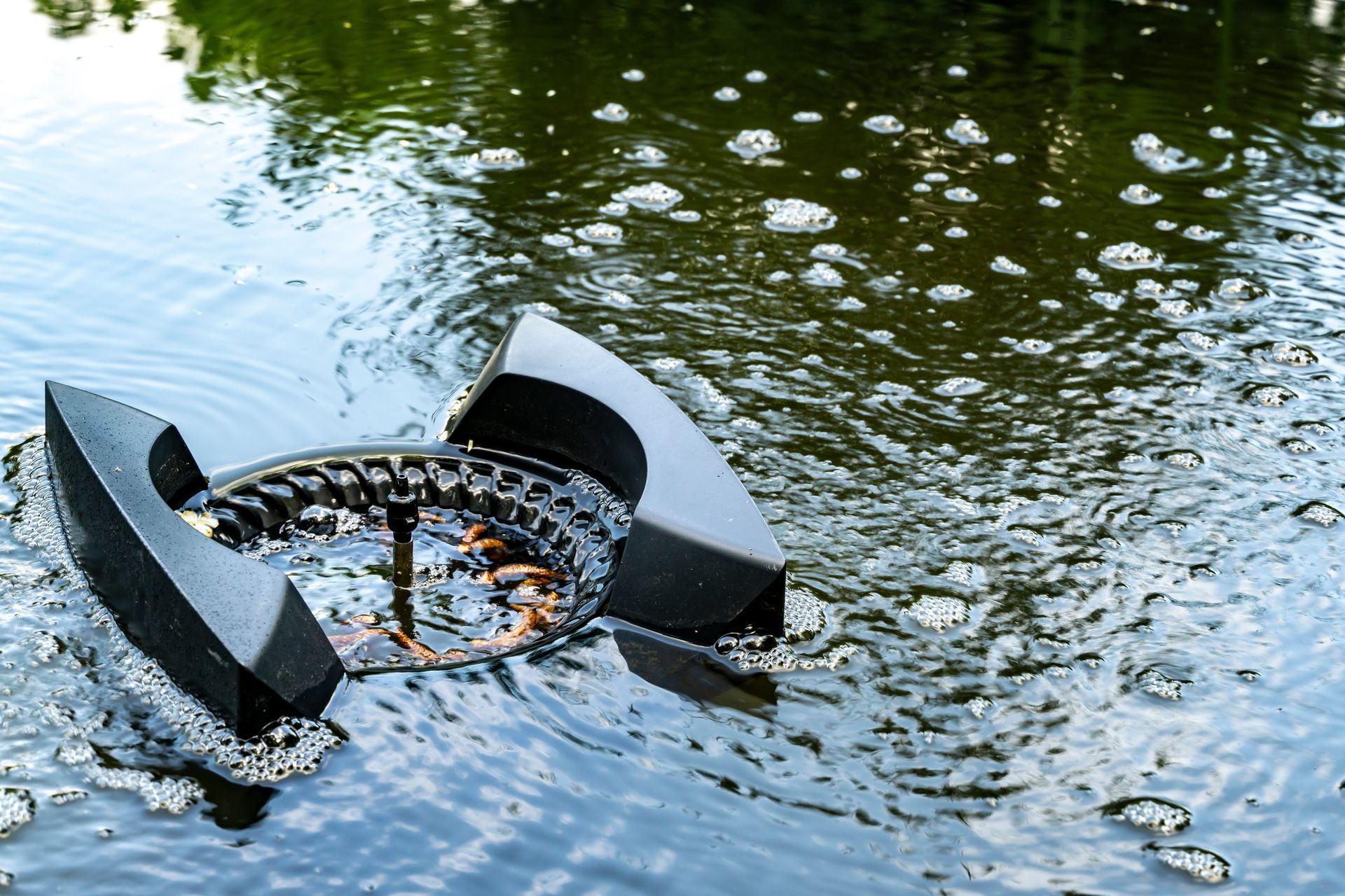 A black object is floating on top of a body of water.