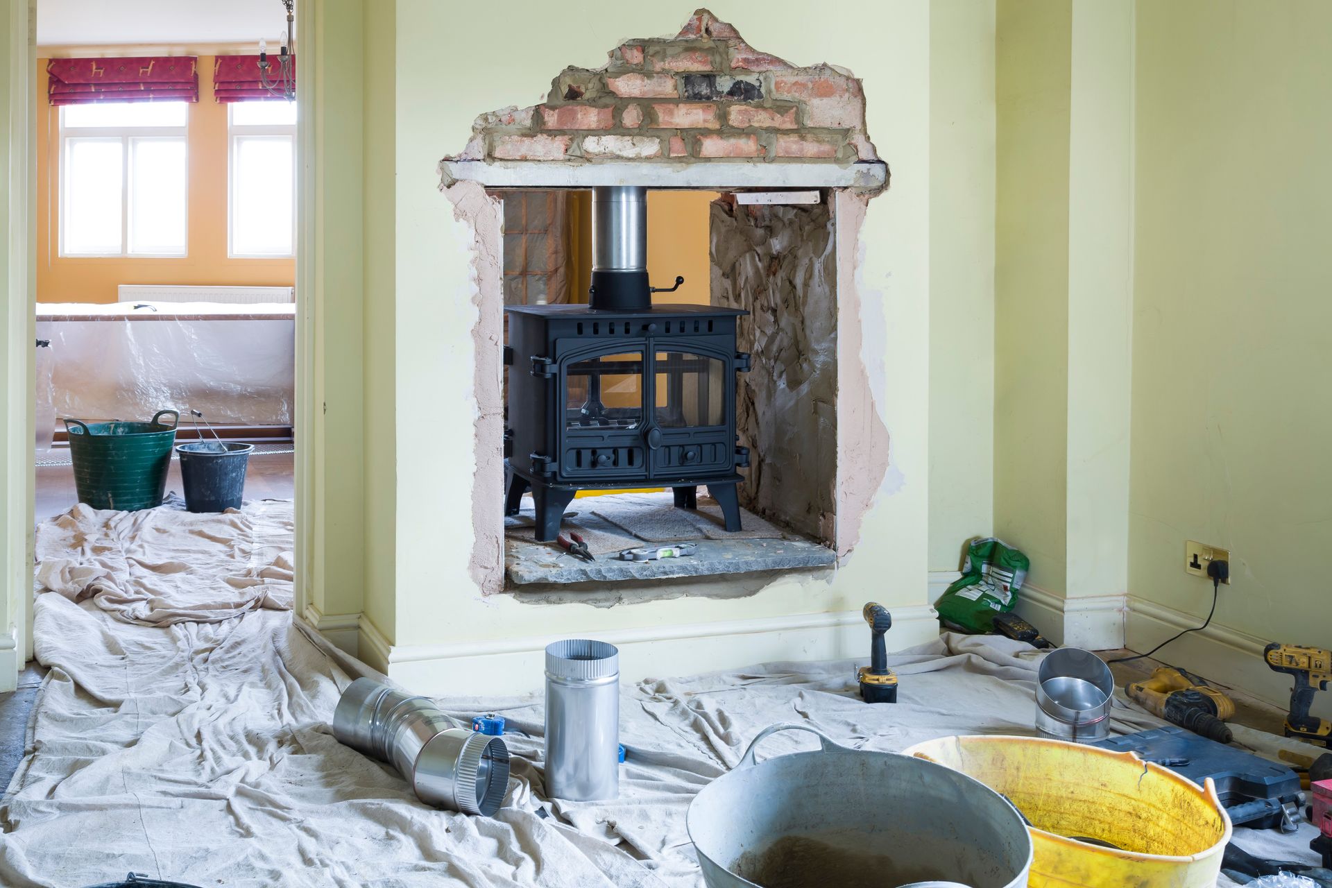 A fireplace is being remodeled in a living room.
