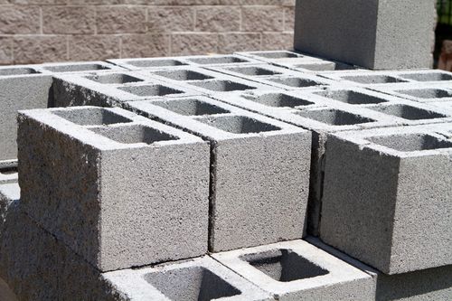 Gray concrete retaining wall built on a hillside.