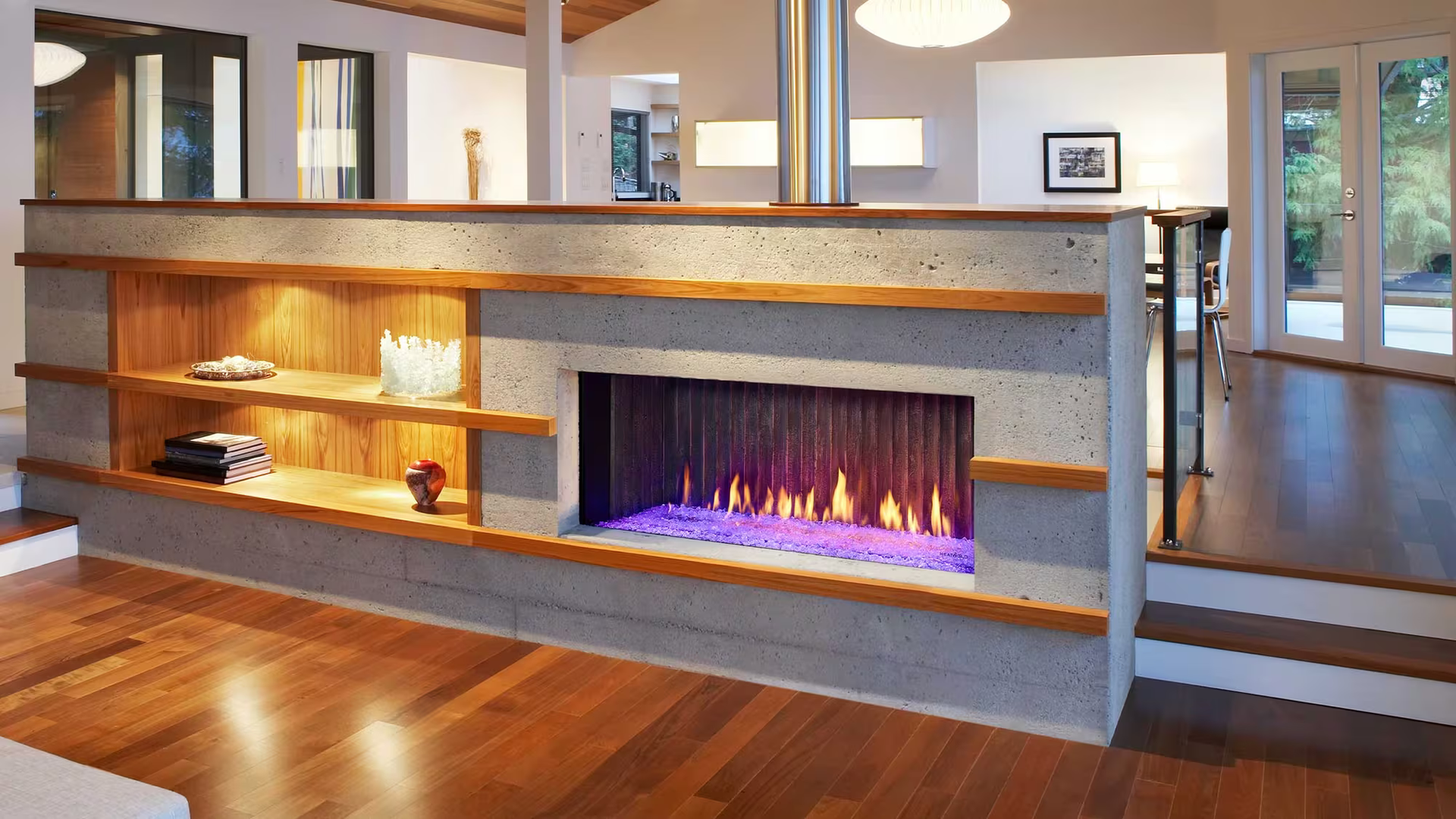 Modern fireplace with shelves, concrete blocks, wood accents, and purple flame.