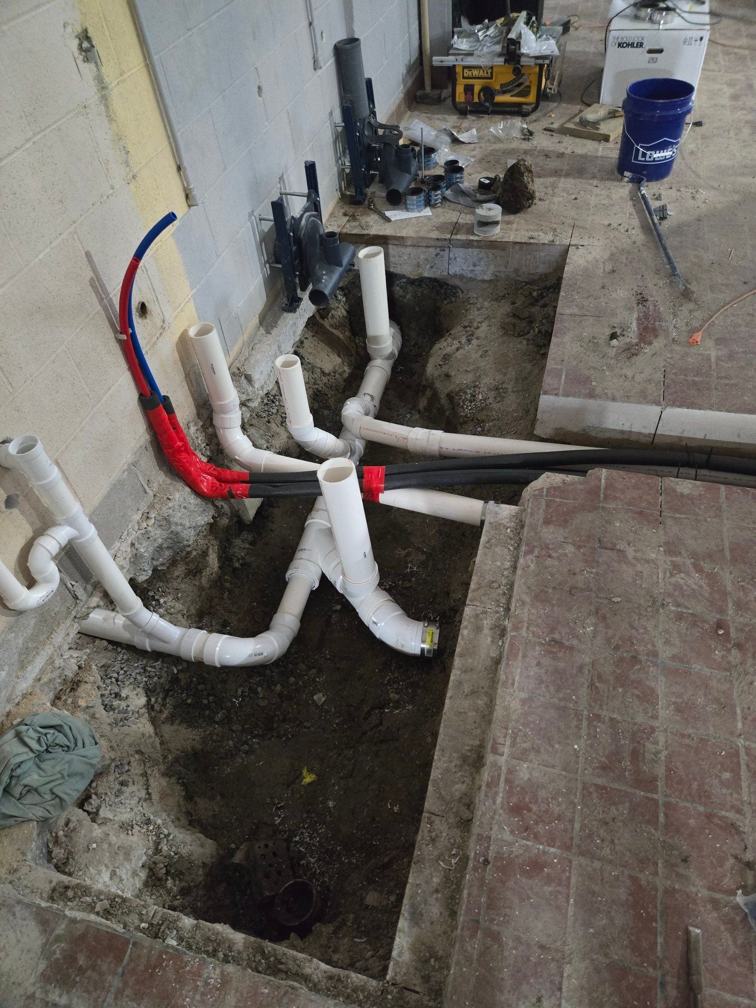 A bunch of pipes are being installed in a hole in the ground.