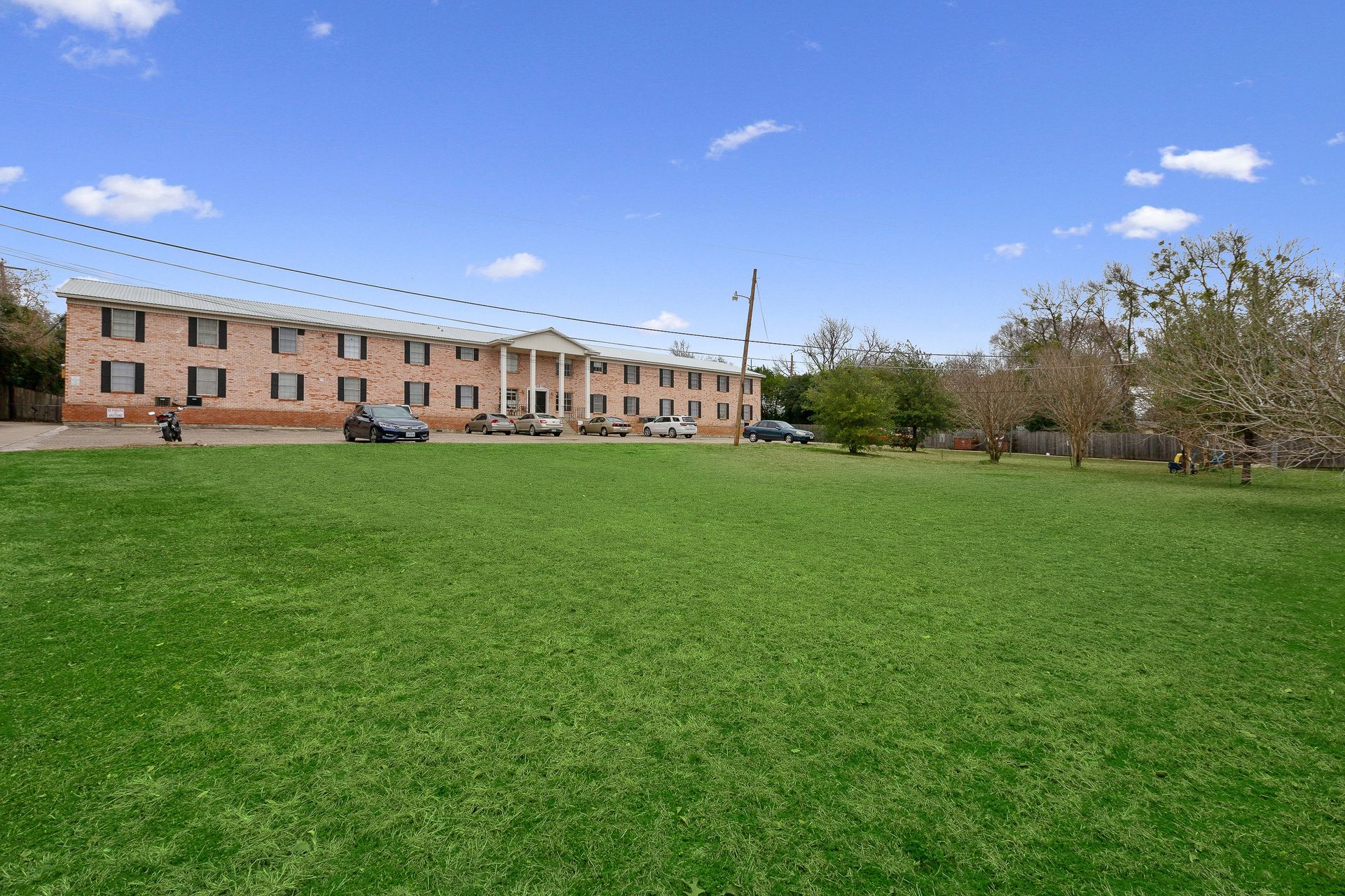 A large building with a lot of grass in front of it.