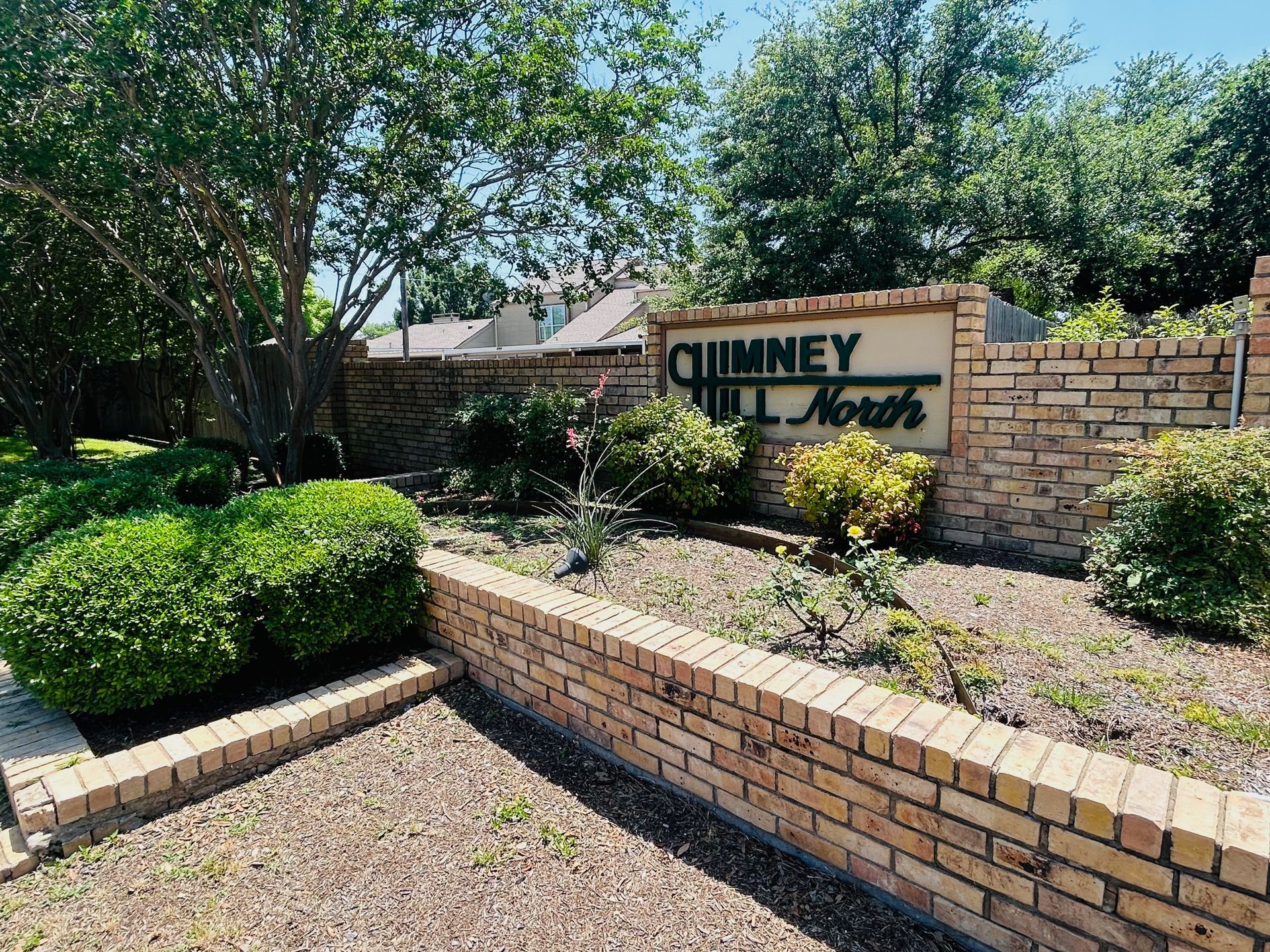 A brick wall with a sign that says chimney north