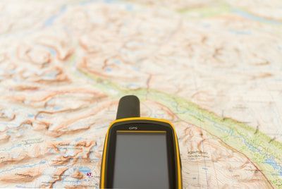 GPS device sitting on top of a map
