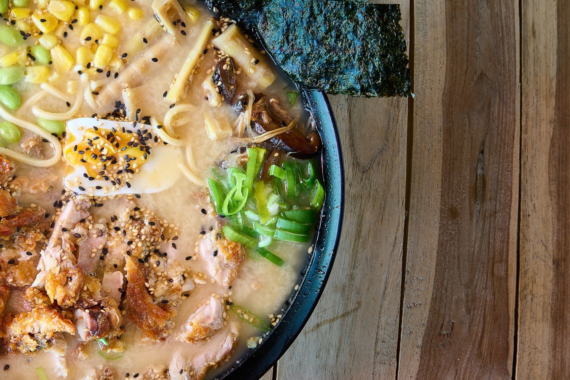 A bowl of ramen on wooden surface