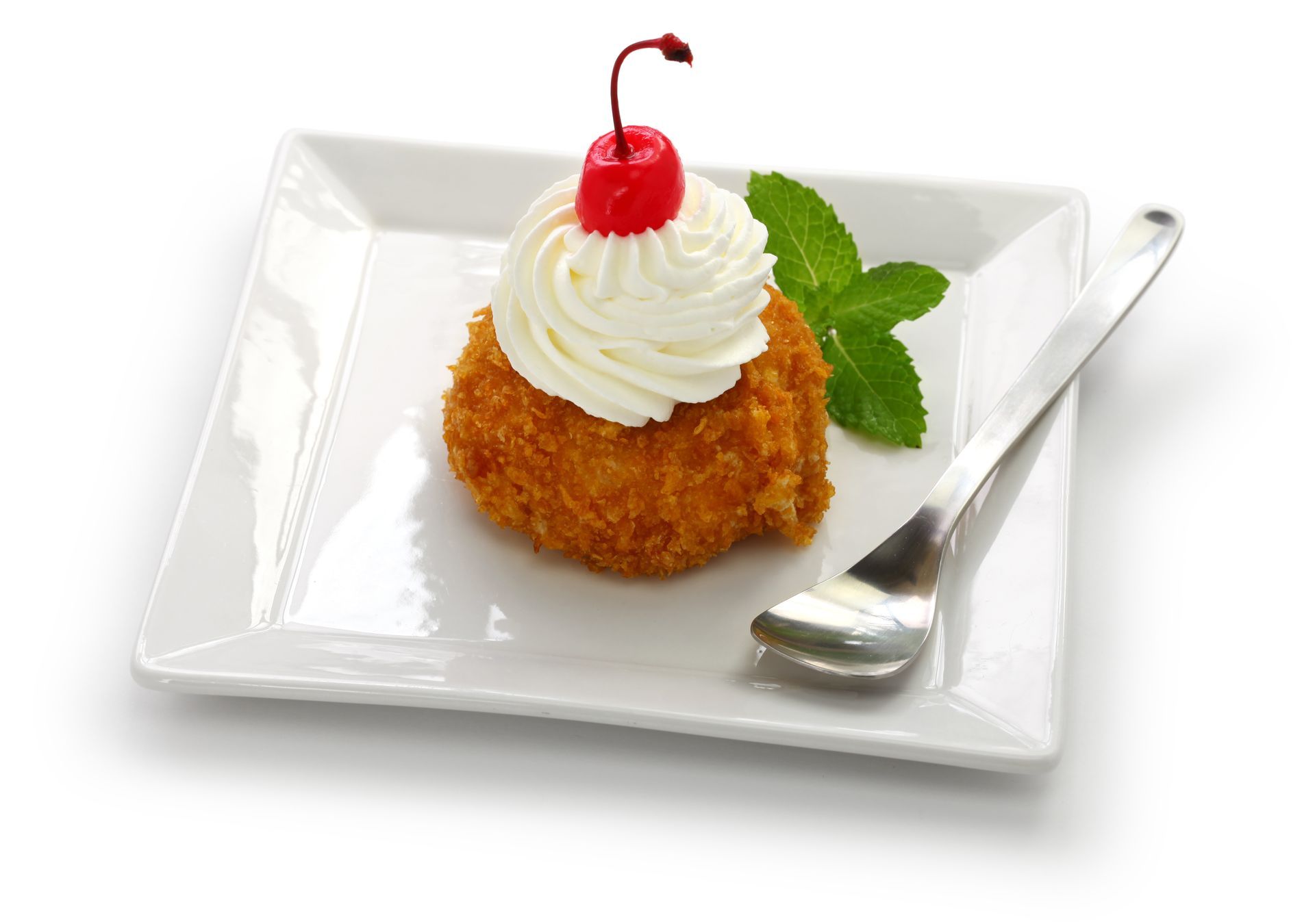 Homemade fried ice cream isolated on a white plate, with a spoon on the side