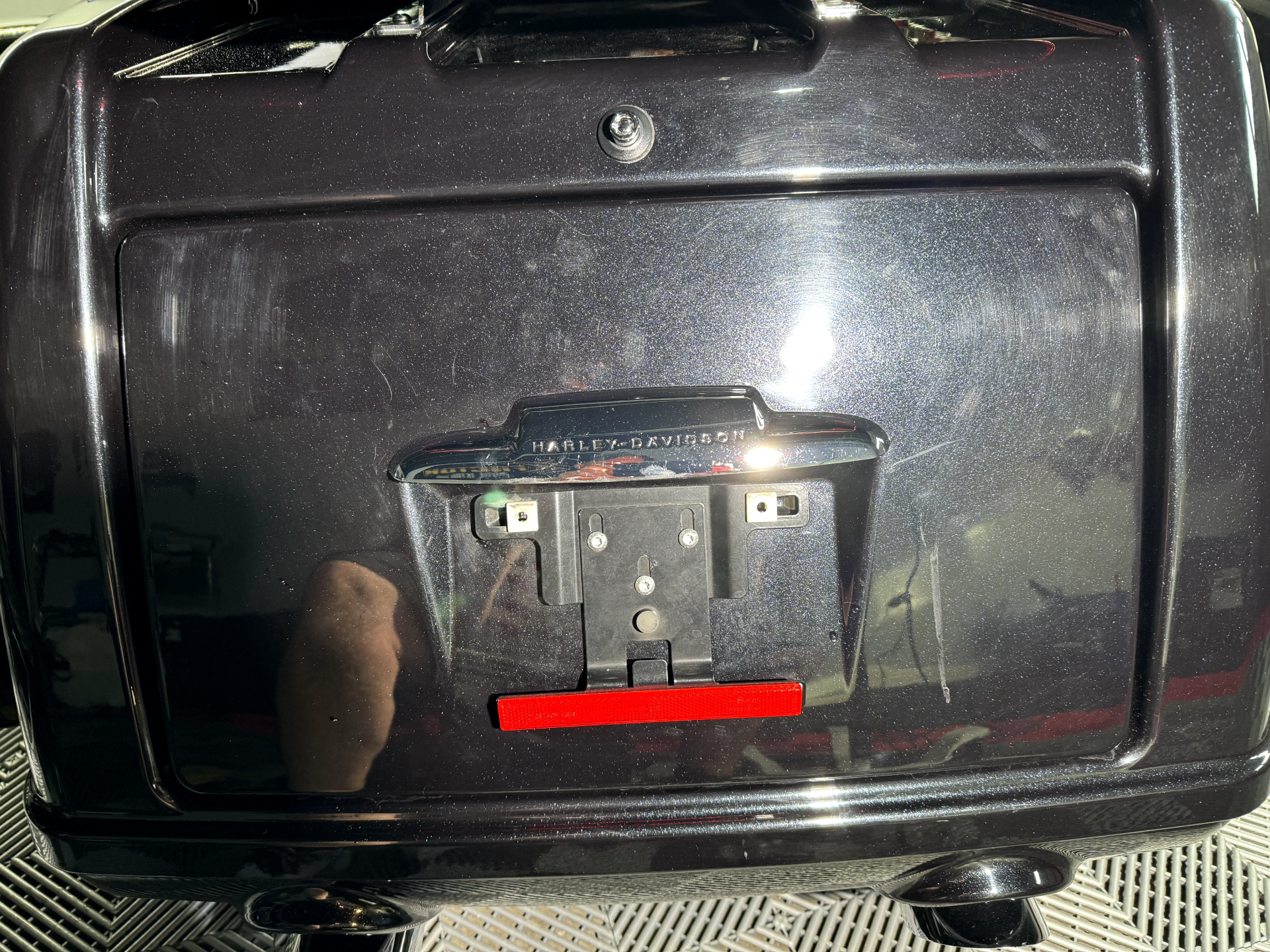 the back of a black motorcycle with a red sticker on it