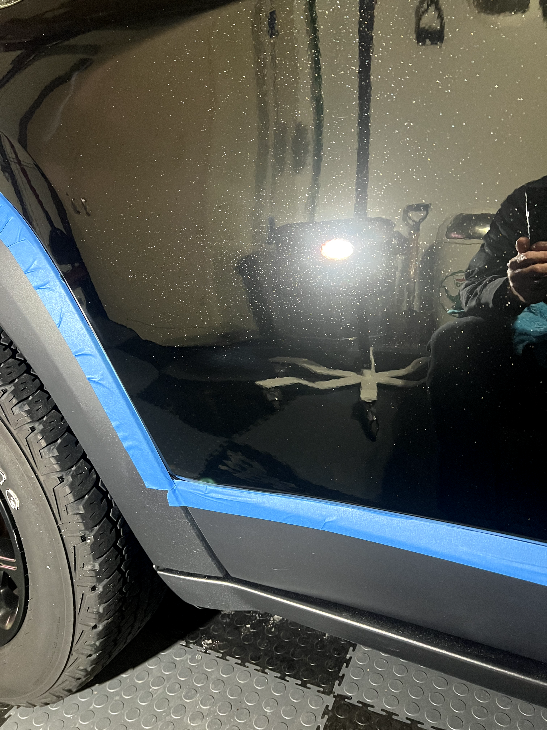 a person is taking a picture of their reflection in a car window .