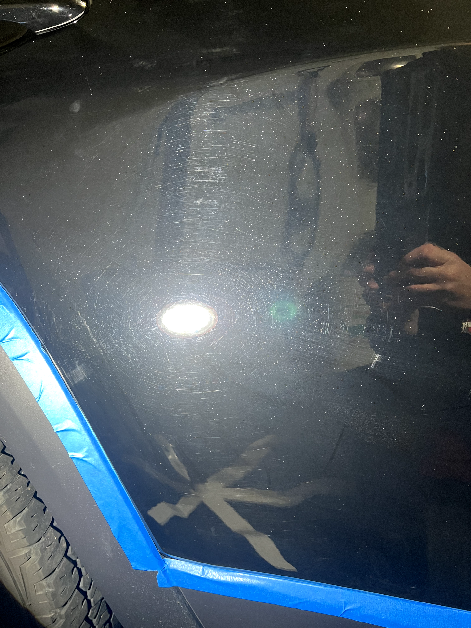 a person is taking a picture of a car with blue tape