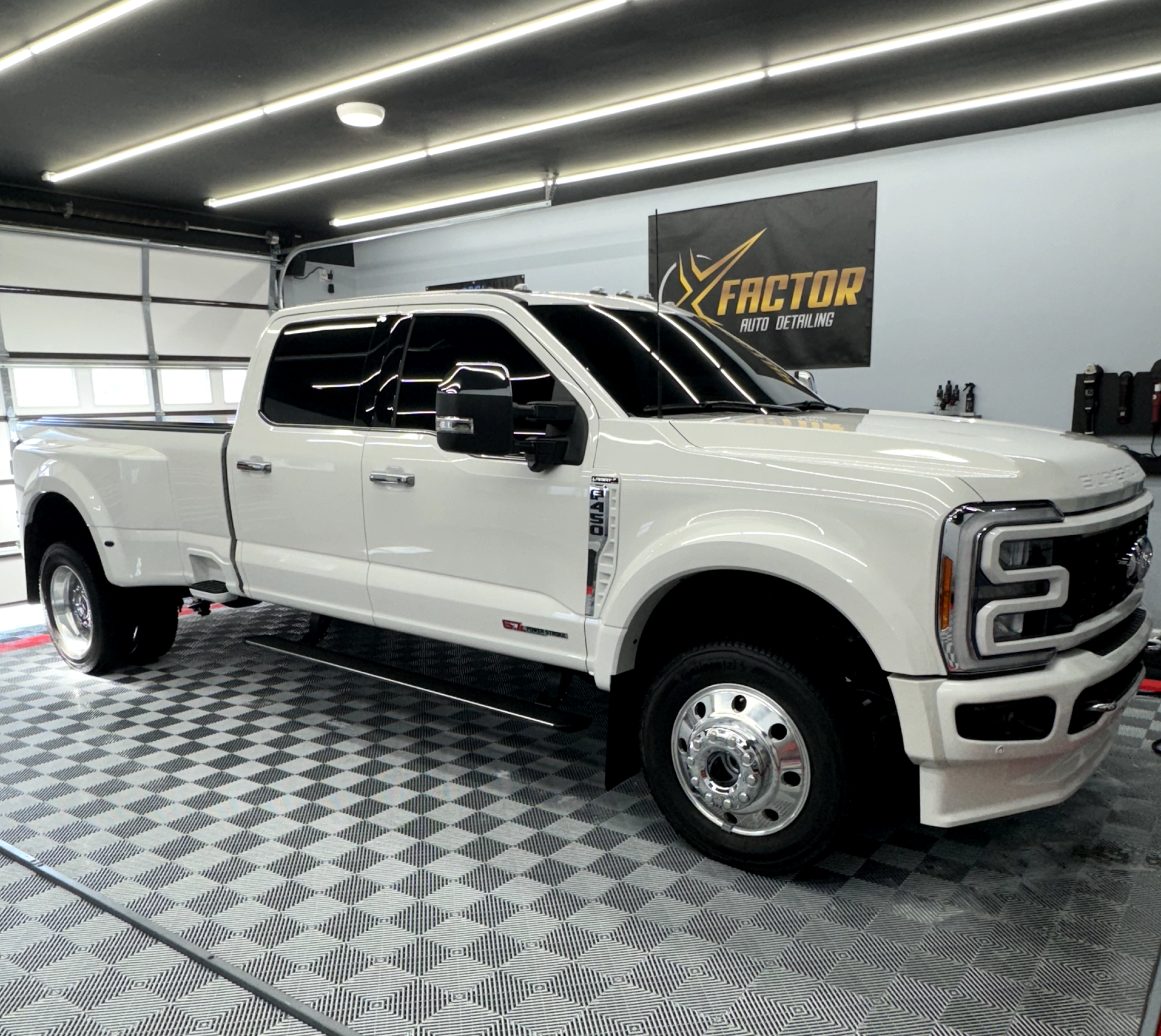 a white pickup truck is parked in a garage .