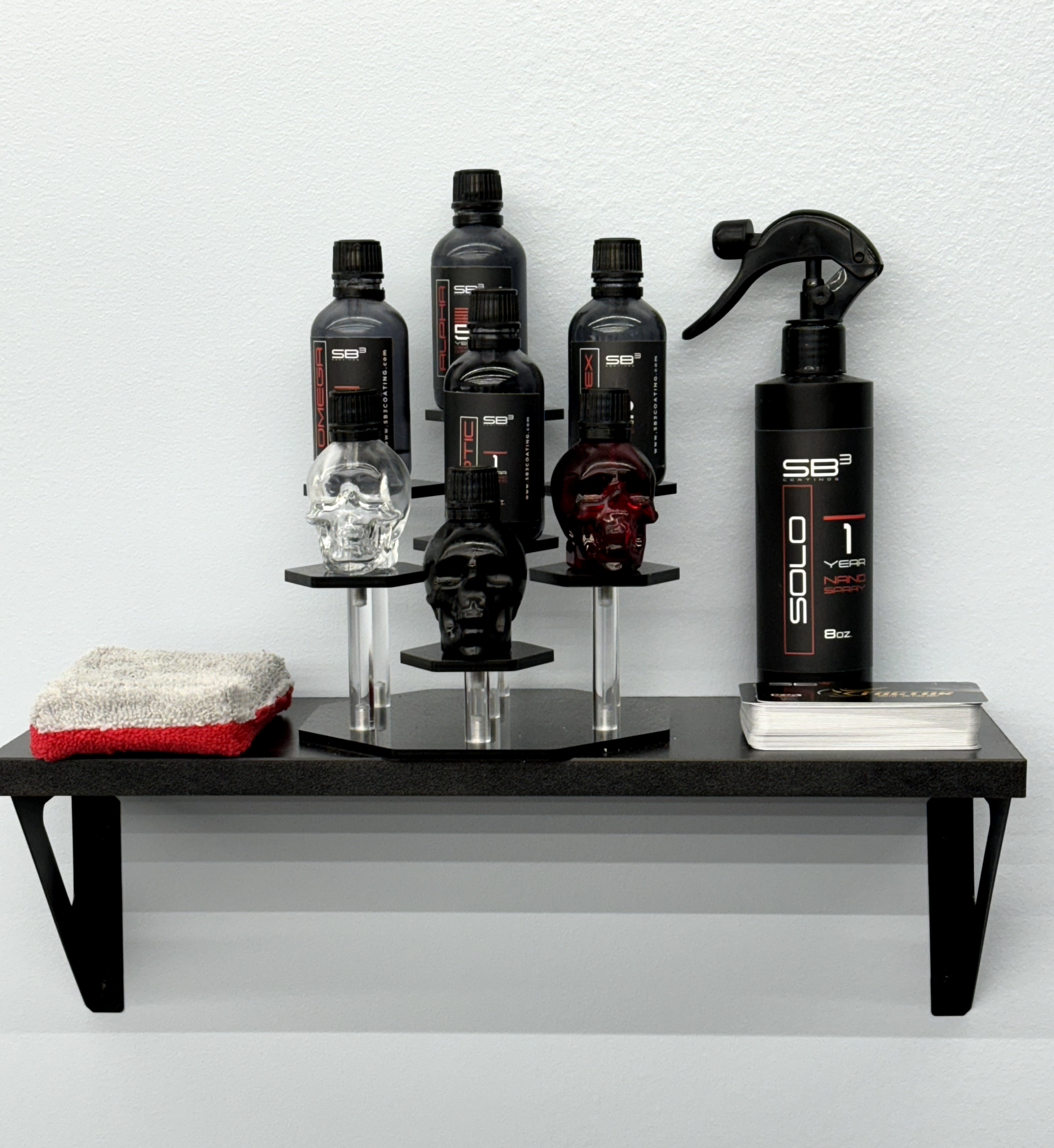 a shelf with skulls and spray bottles on it