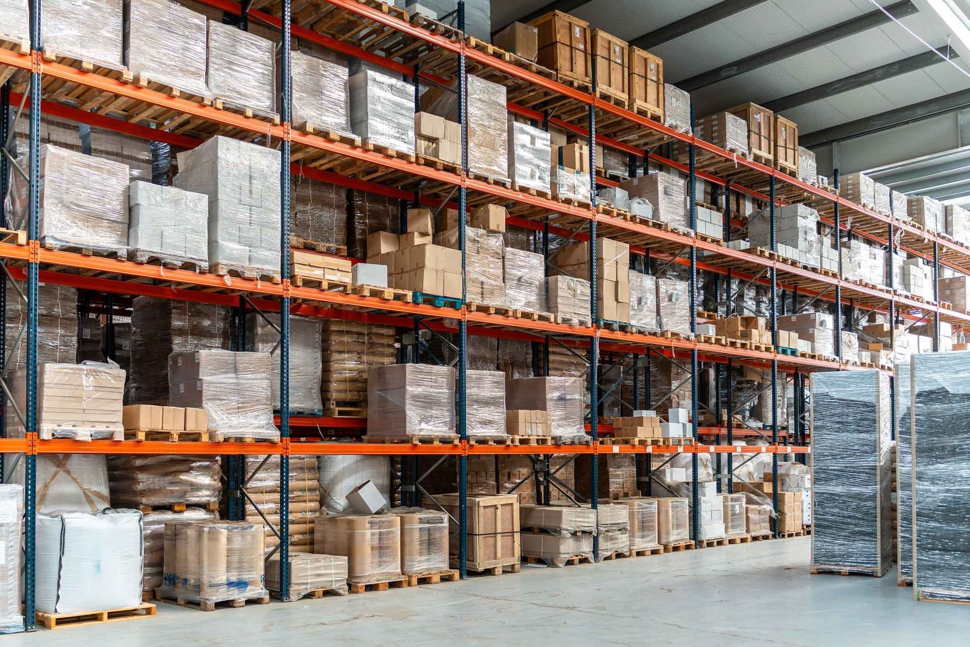Warehouse shelving stacked with cardboard boxes and wrapped packages. Warehouse shelving stacked with cardboard boxes and wrapped packages.
