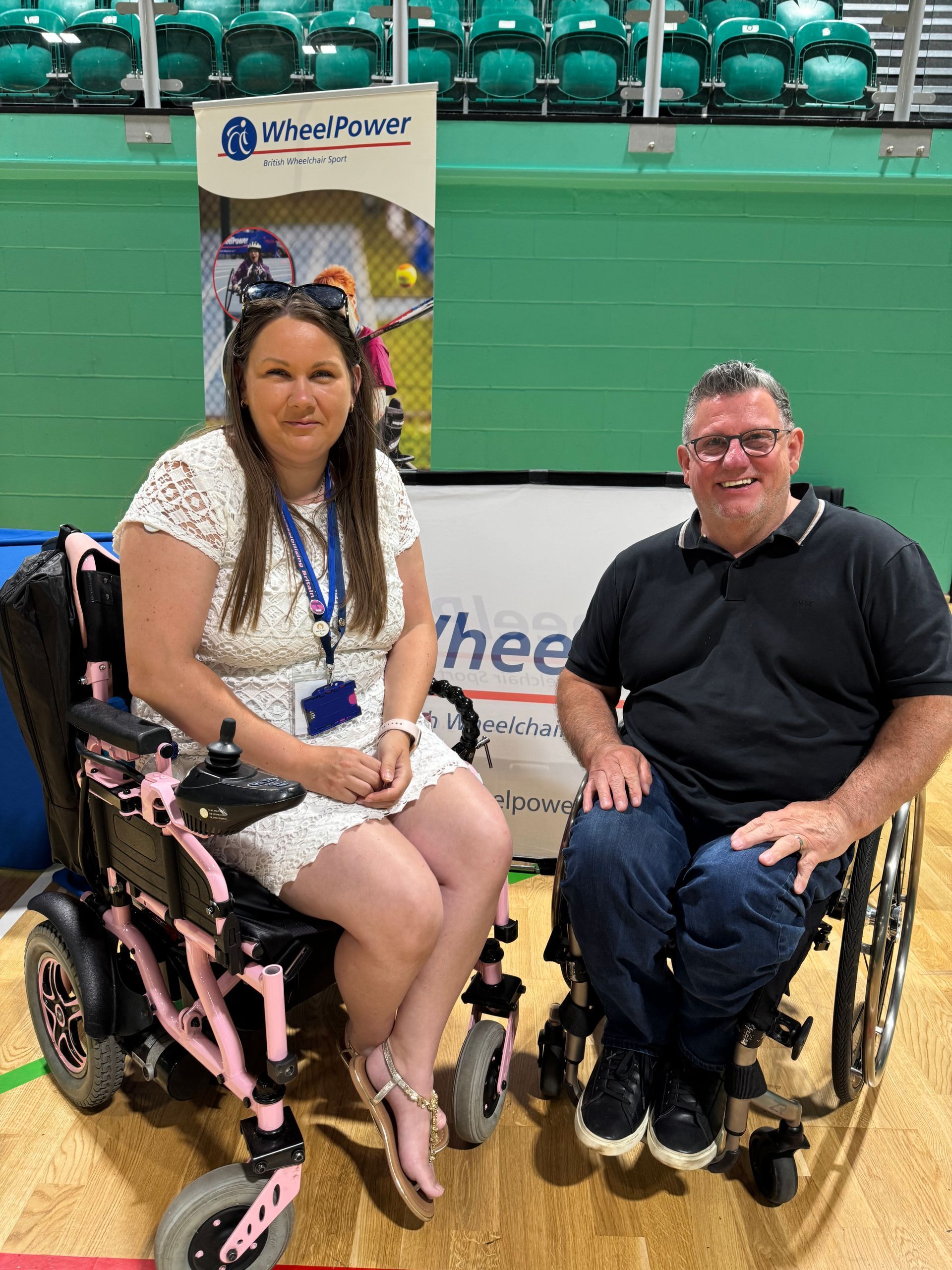 Victoria-Jayne sits in her pink wheelchair ext to Martyn from Wheelpower