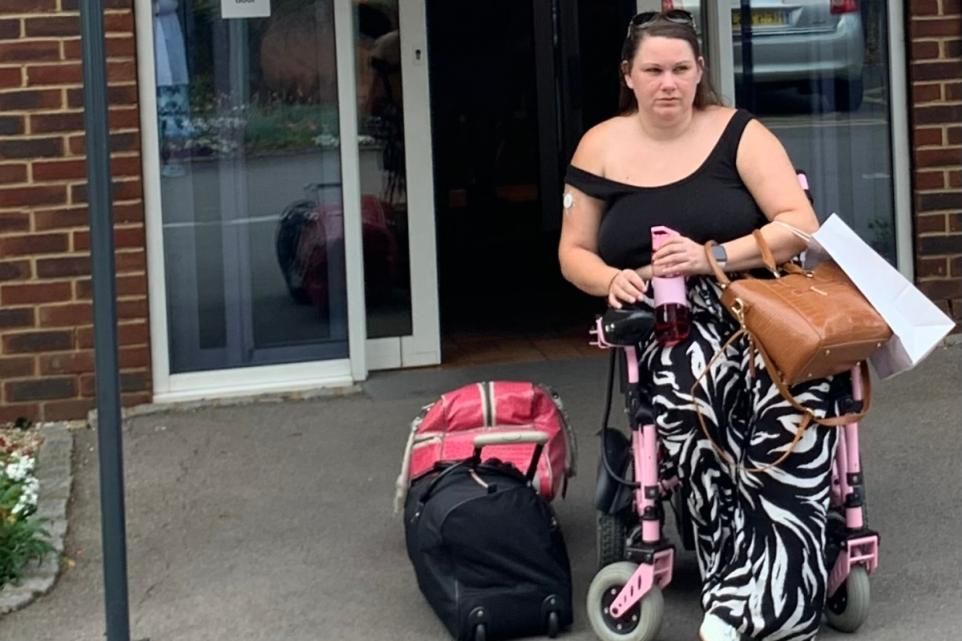 Victoria sits in her wheelchair with zebra stripped trousers on after a day at the spa. 