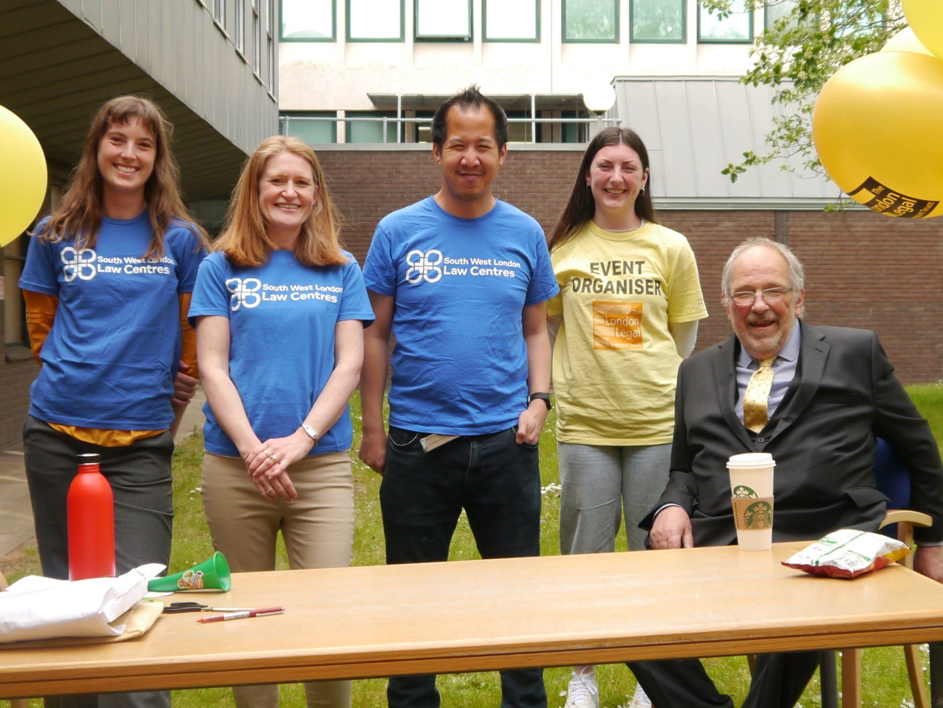 South West Law Centre employees and Bob Nightingale sat behind a table.