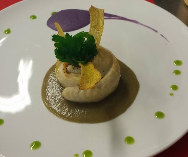 Un piatto bianco con sopra un fungo e salsa