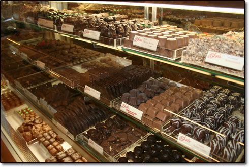 A variety of chocolates are on display in a store