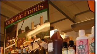 A shelf with bottles of organic foods on it