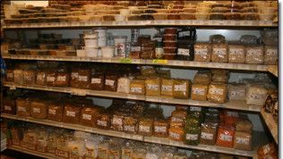 A grocery store shelf filled with lots of different types of food