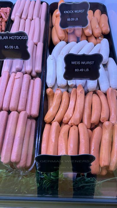 A display case filled with lots of different types of sausages.
