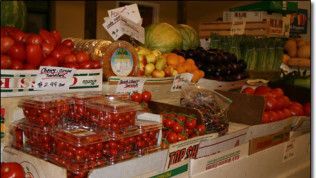 A variety of fruits and vegetables are on display at a market.