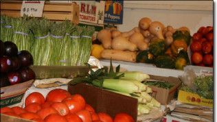 A variety of fruits and vegetables including tomatoes and corn