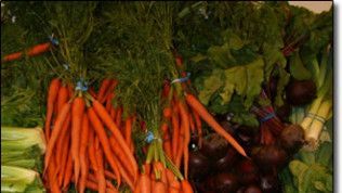 A bunch of carrots and other vegetables on a table