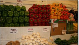 A display of vegetables including peppers and mushrooms